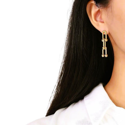 Boucles d’oreilles dorées en acier inoxydable iconique